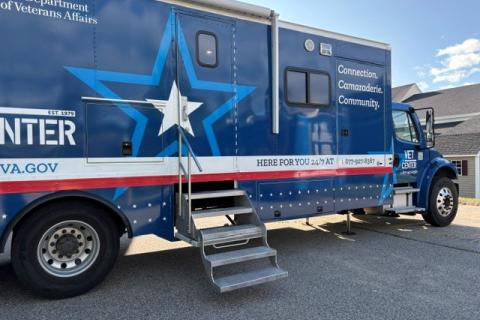 Blue and white mobile unit with star graphic, parked on pavement.