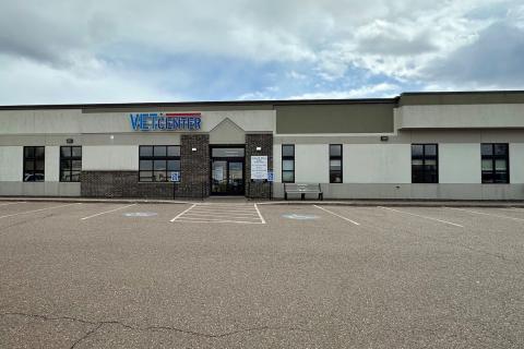 Empty parking lot in front of Vet Center building with "Vet Center" sign.