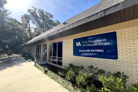 Exterior of brick building with blue sign, VA Department of Veterans Affairs.