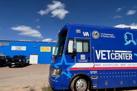 Blue Vet Center vehicle parked in front of blue building.