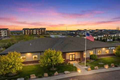Aerial view of a building at dusk with American flag.