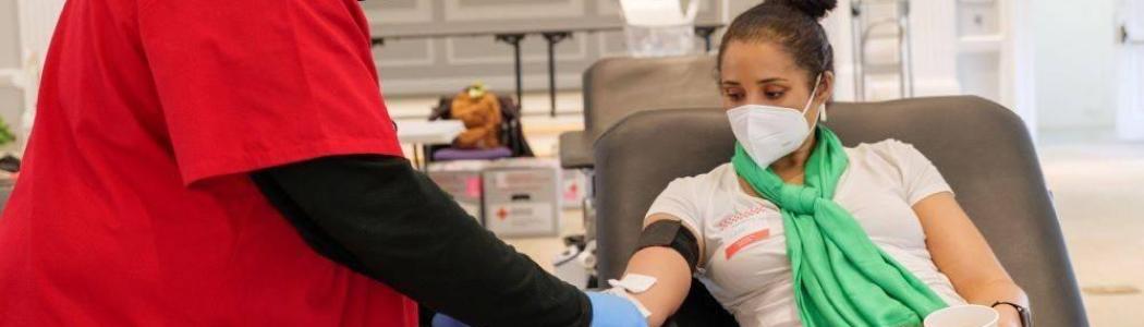 a person donating blood to the Red Cross