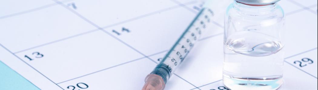 vaccine with needle on a calendar