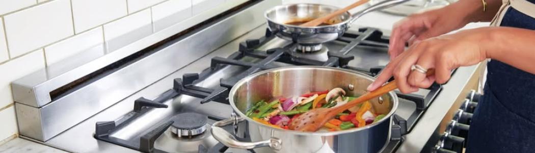 Cooking over a stove. 