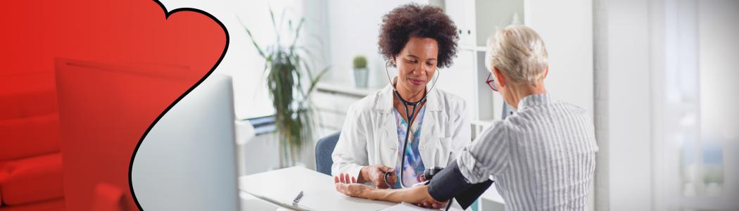 Clinical staff taking blood pressure of patient