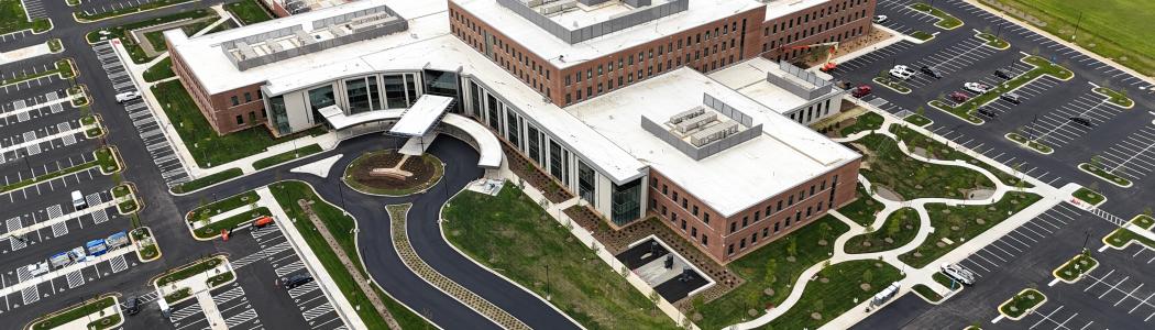 Overhead drone footage of medical center and parking lot.