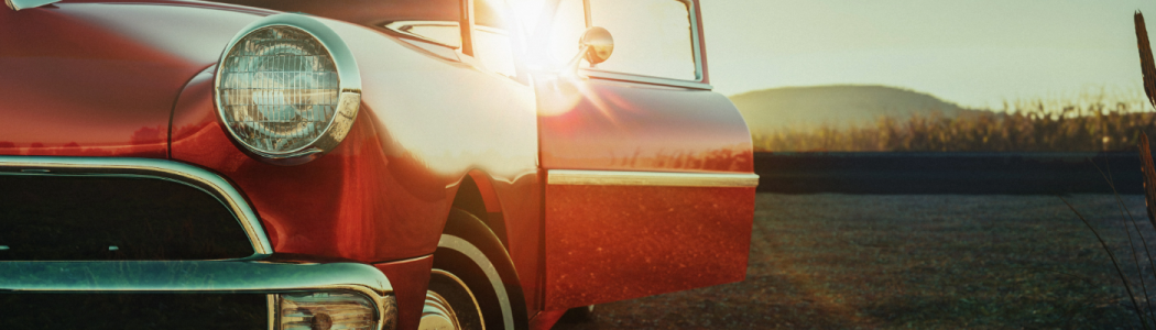 classic car in front of sunset