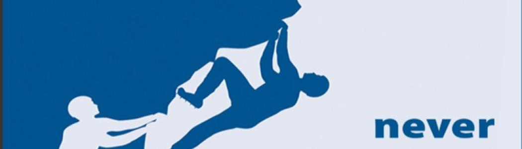 Silhouette of person climbing a mountain.