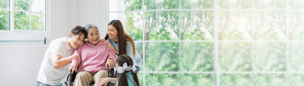 Family members gathered around a woman in a wheelchair