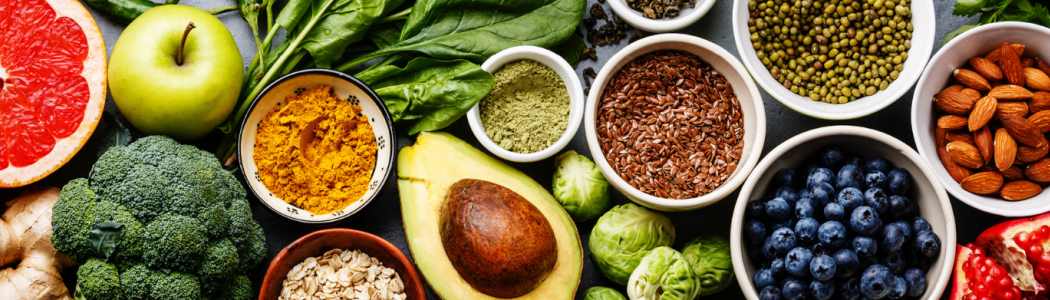 Various fruits, vegetables, and superfoods arranged in bowls.