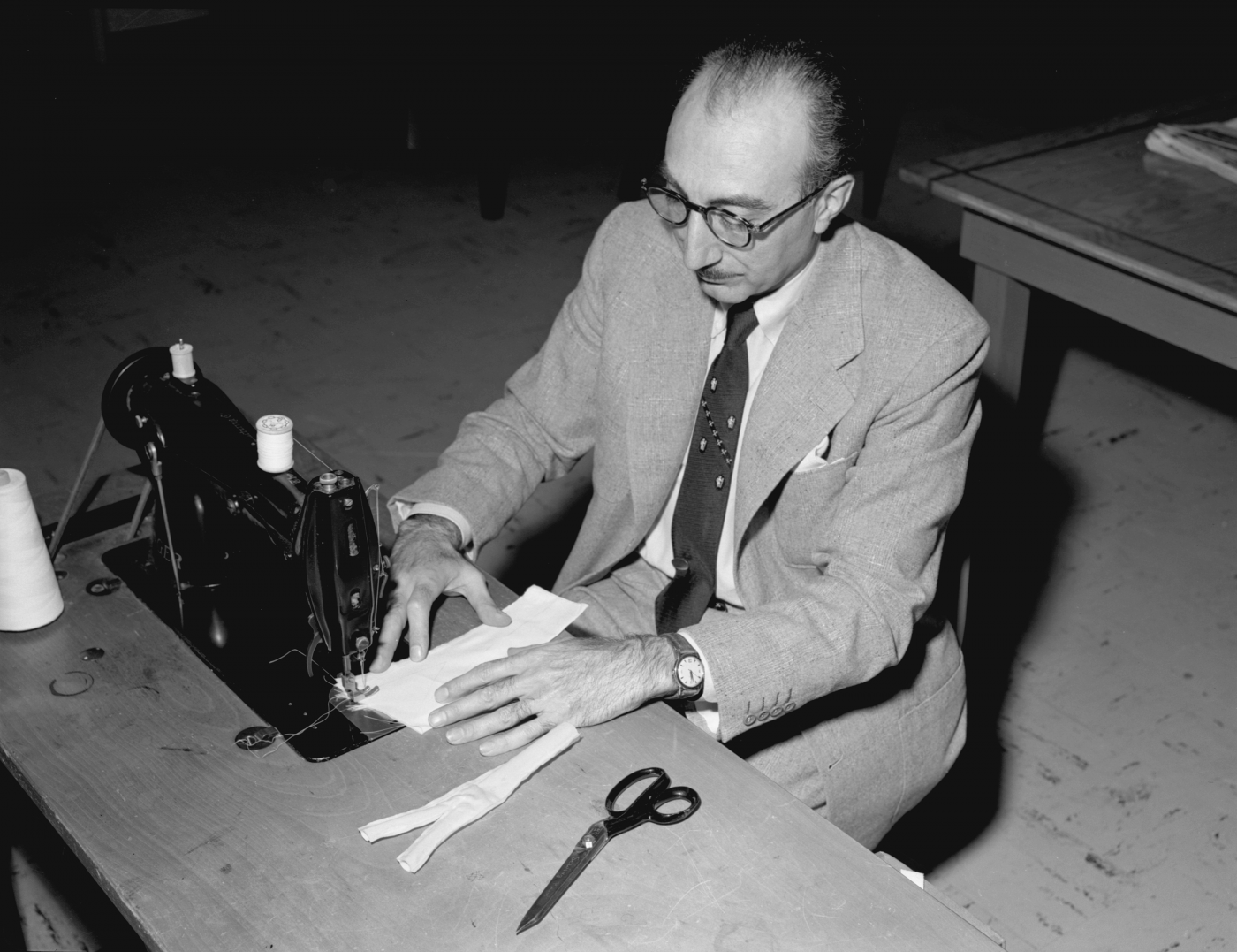 Dr. Michael E. DeBakey at sewing machine.