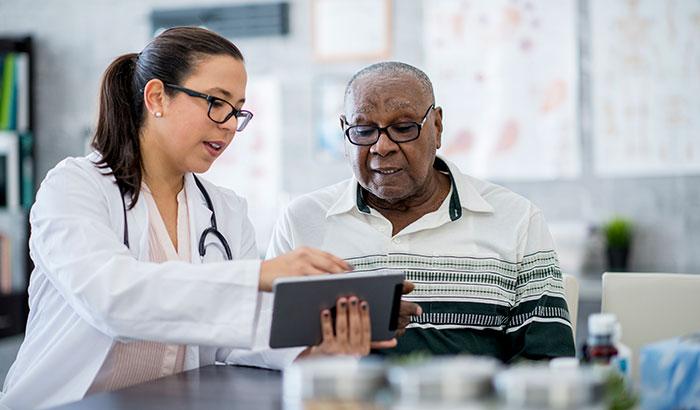 Female doctor talking to male patient