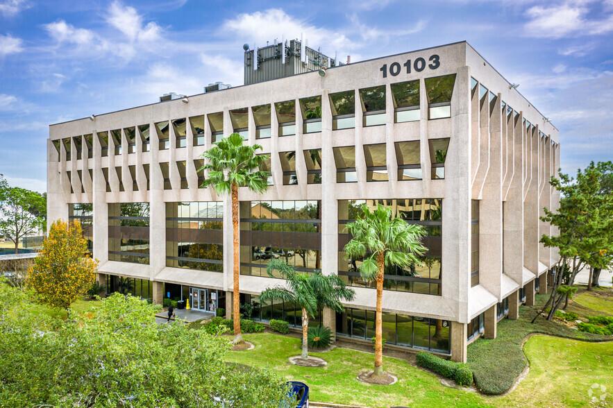 blue skies, large white building, 10103 Fonden road, Palm trees