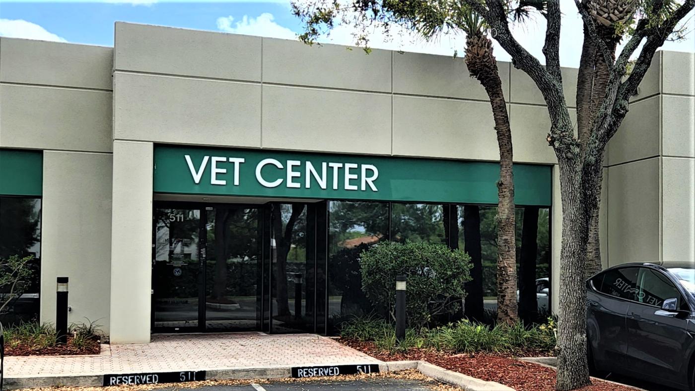 Image of the Miami Vet Center as seen standing in front of it. Green banner with white text that reads Miami Vet Center is seen.