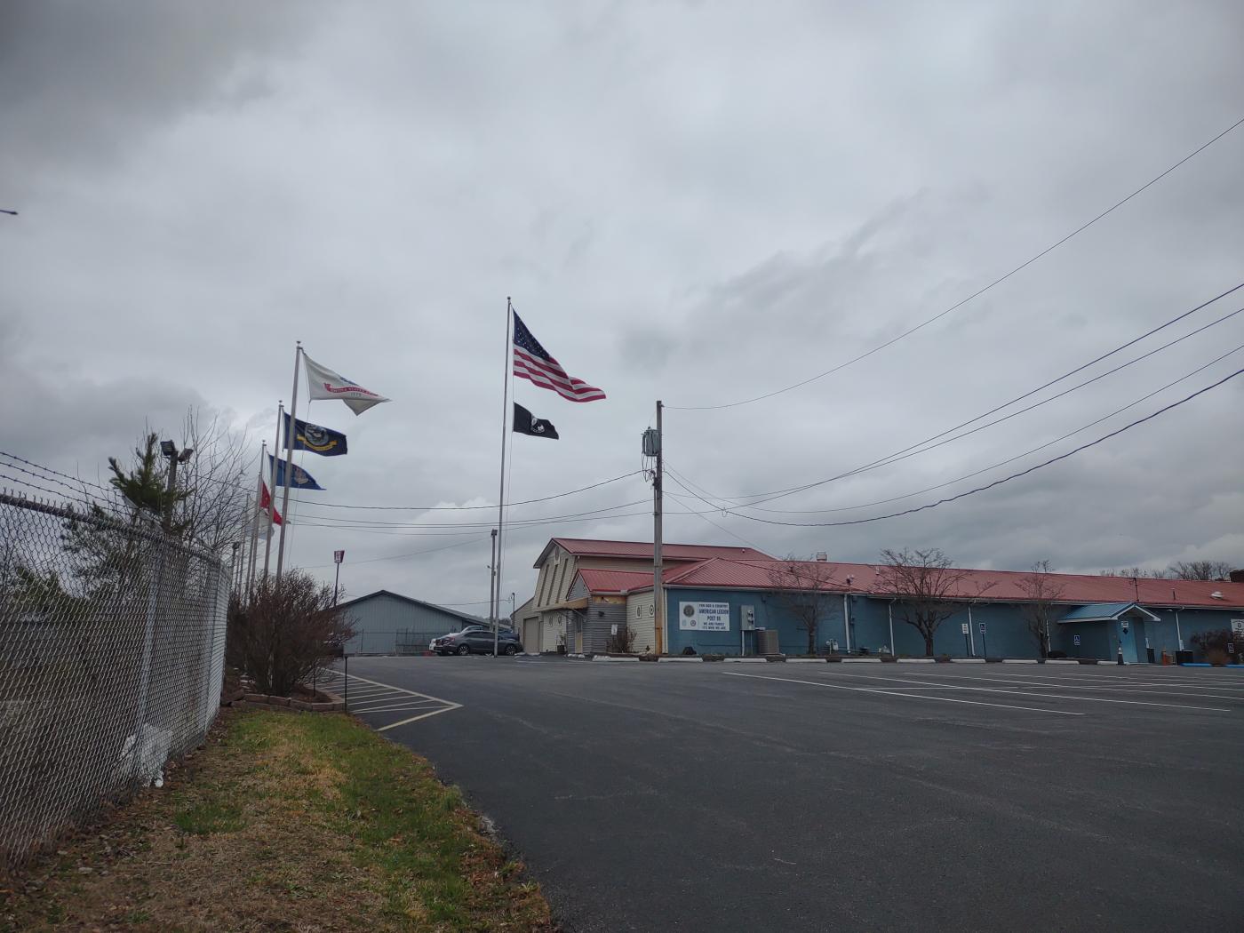 Building on hill with flags flying at front