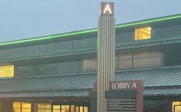 The exterior of Domino Farms Satellite Office with a tall pole topped with the letter A.