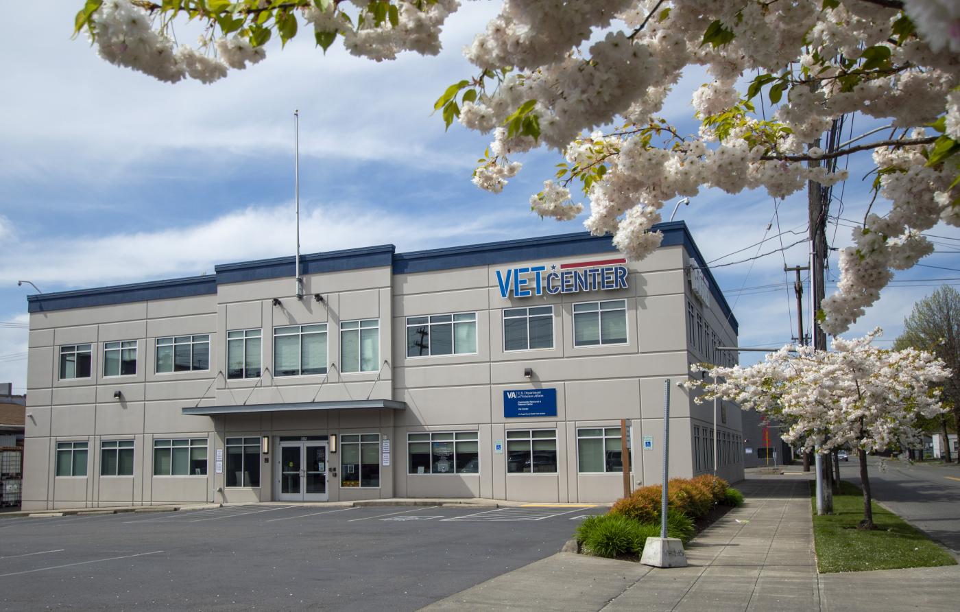 Front view of Building with Seattle Vet Center sign prominently displayed on side of building. Doors in middle of building are the front entrance.