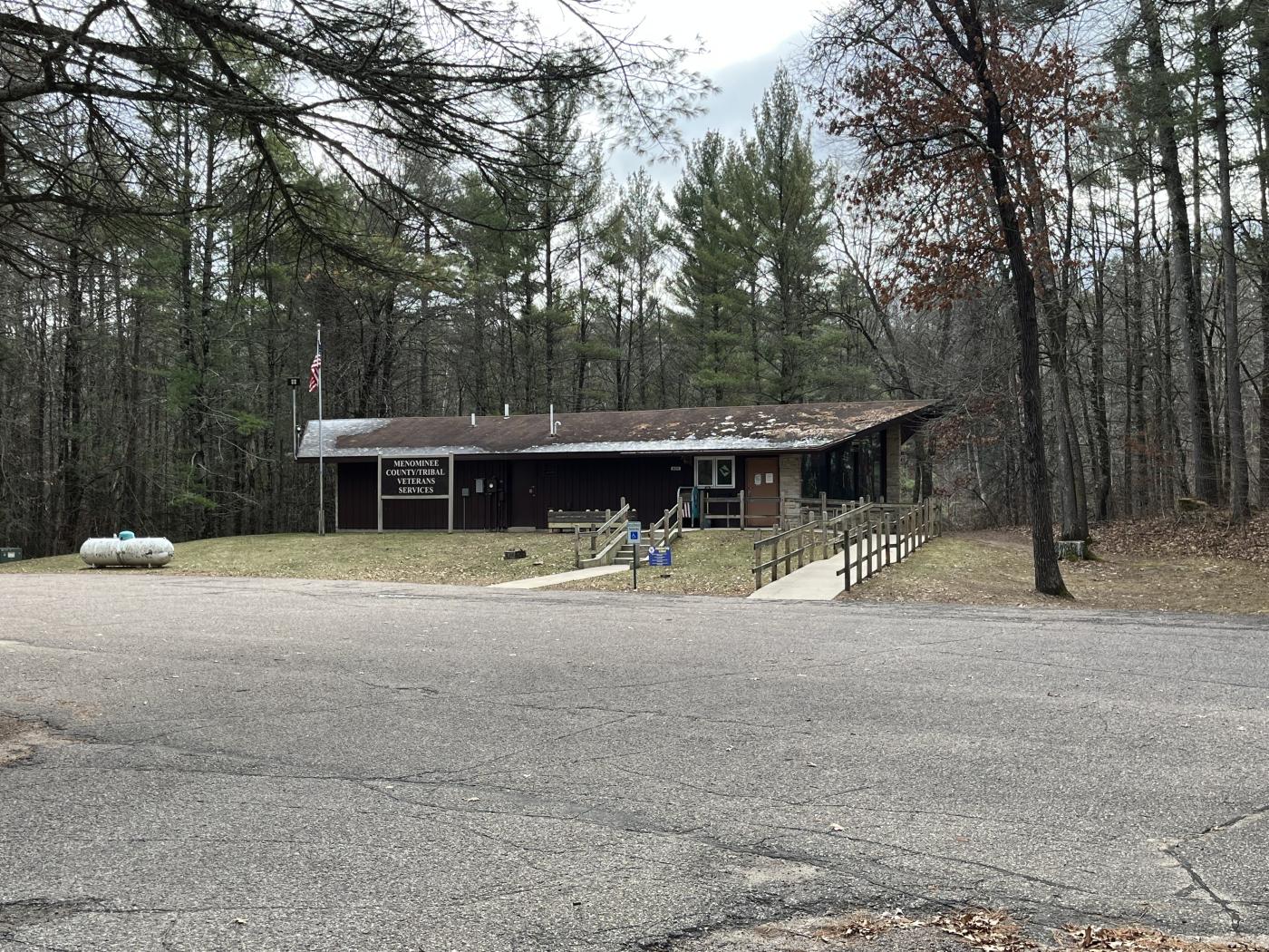 Driving into the parking lot you will see a small building in the woods with a wheelchair ramp. With a Menominee County / Tribal VSO sign in front.