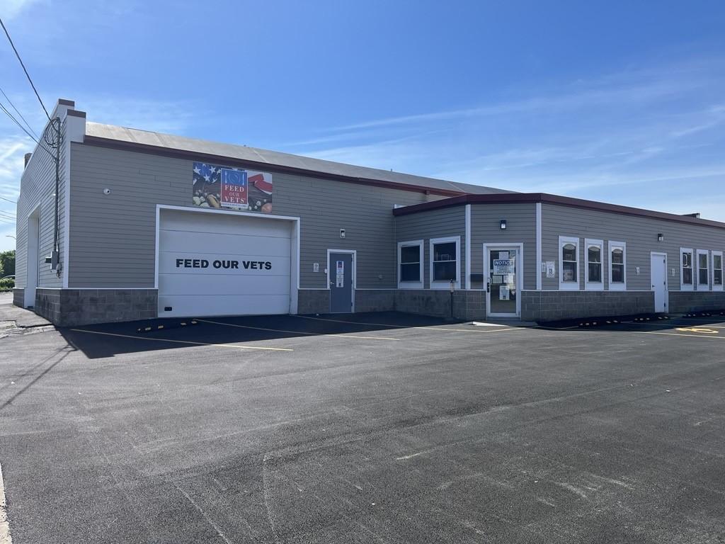 one story light gray building with white trim