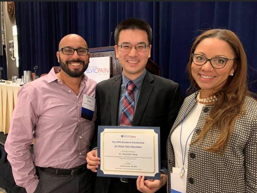Three Orlando VA staff in the Minimally Invasive Gynecology Surgery program stand posing holding a scholarship certificate and smiling.