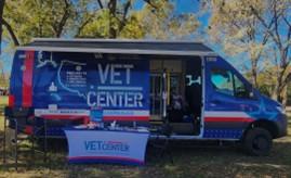 Blue van with red and white details including the Vet Center logo