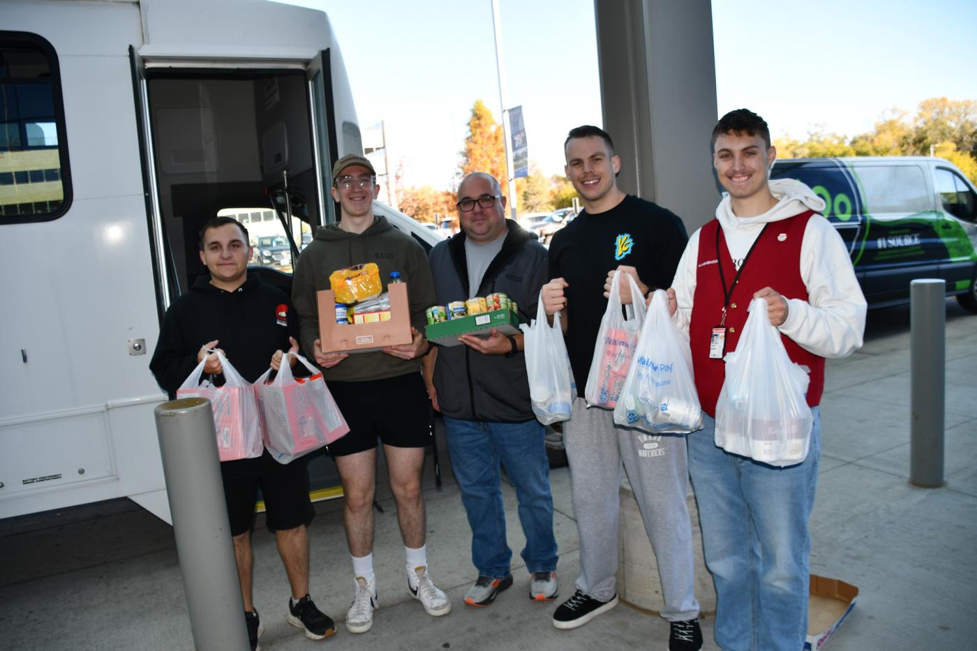 Volunteers hold bags of food donations for the Veterans Food Pantry on November 7, 2025.