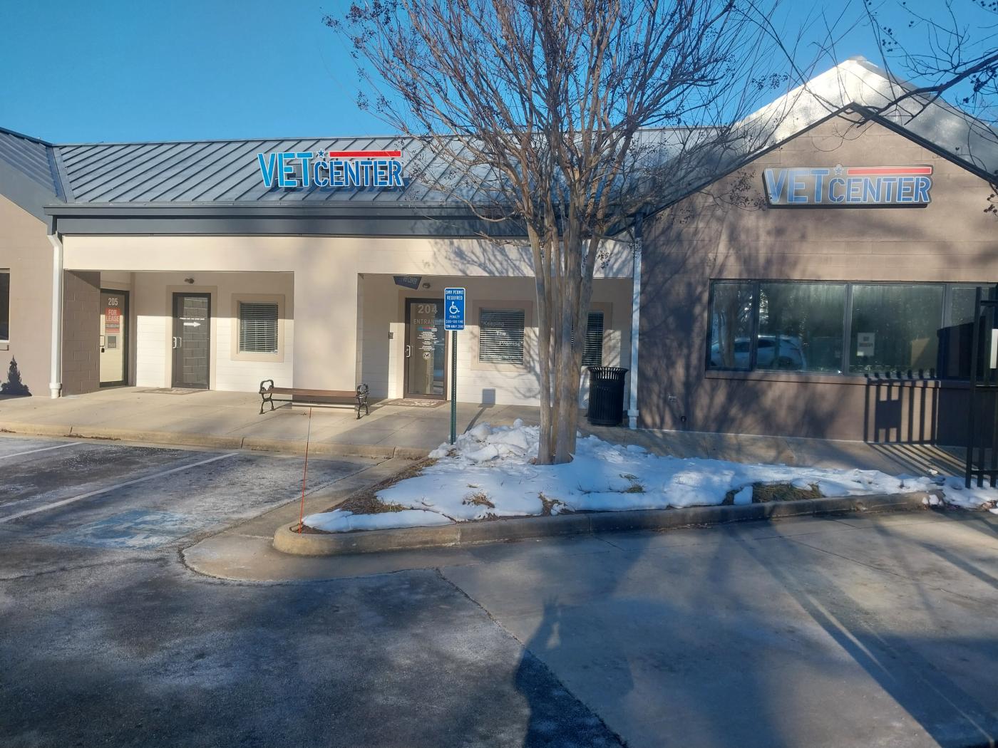 Vet Center building with snowy ground and leafless tree.