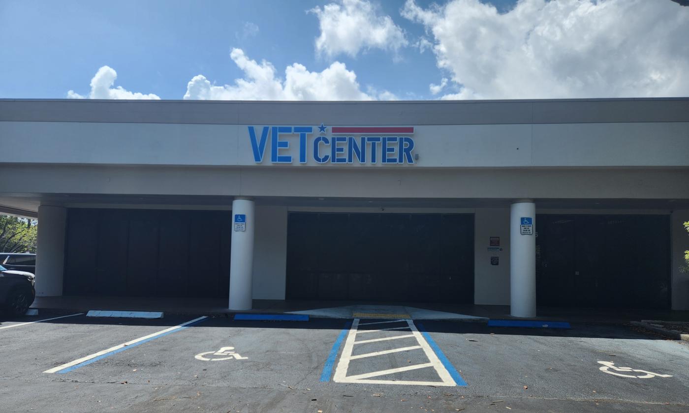 Vet Center building with large sign, two pillars, and parking lot.