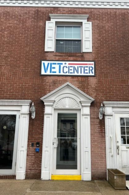 Vet Center sign above brick building entrance with white trim and glass door.