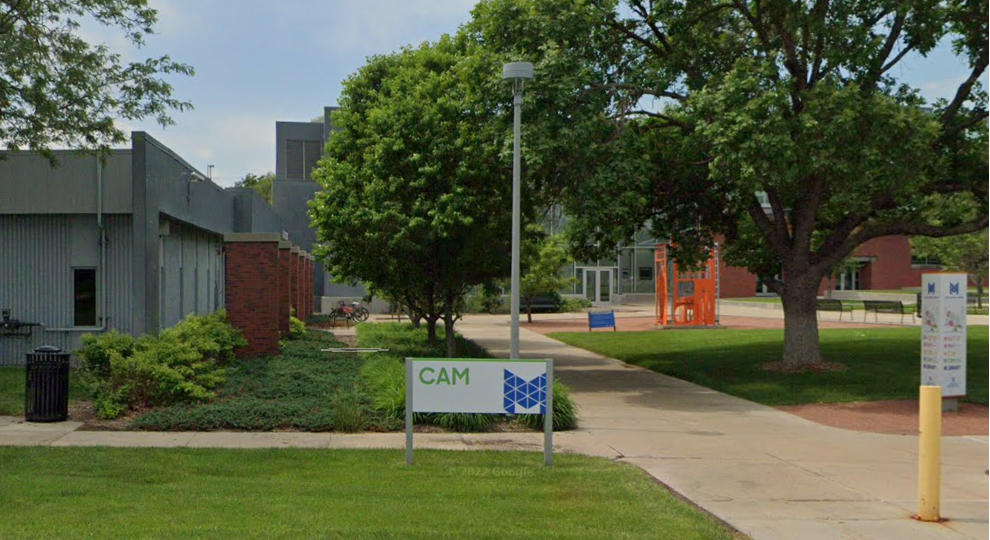View of the front of the CAM building from the parking area.