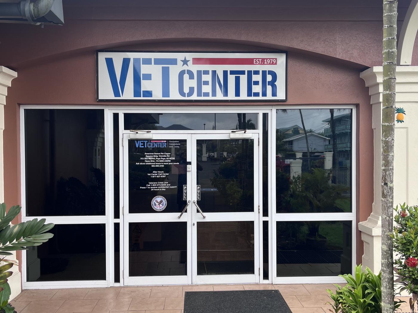Vet Center sign above double glass doors with black mat in front.