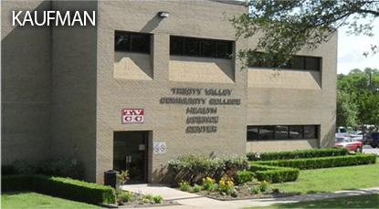 Kaufmann building with bushes, grass, and a small tree.