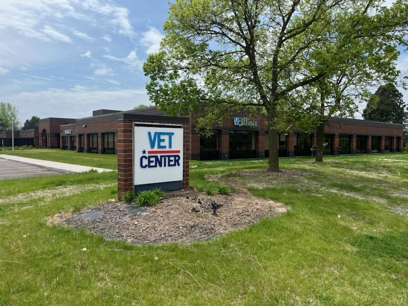 Vet Center sign in front of building with green lawn and tree.