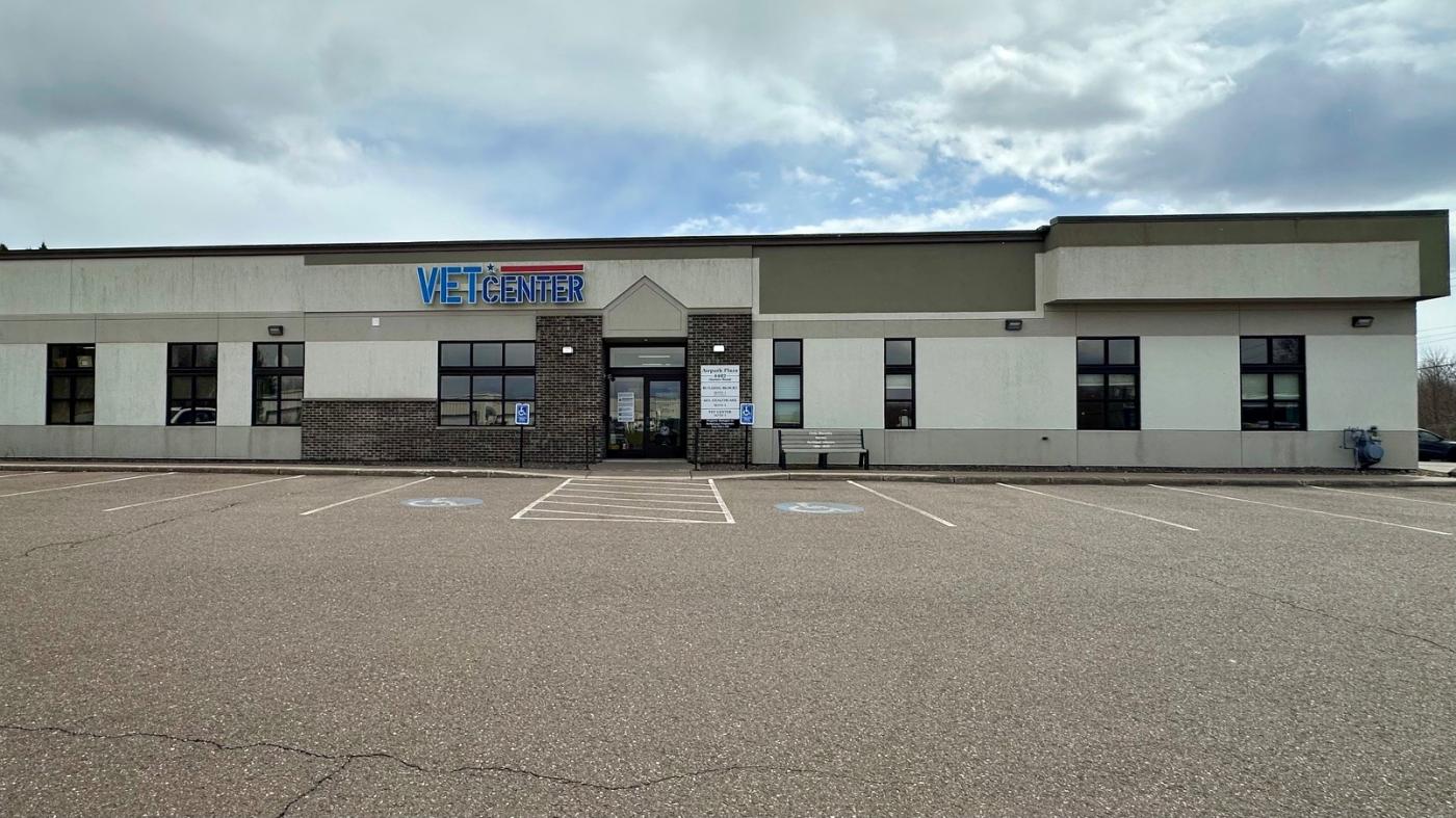 Empty parking lot in front of Vet Center building with "Vet Center" sign.
