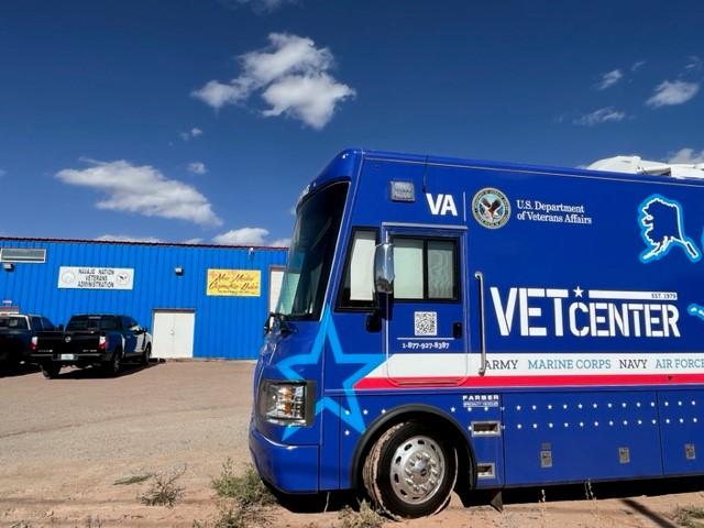 Blue Vet Center vehicle parked in front of blue building.