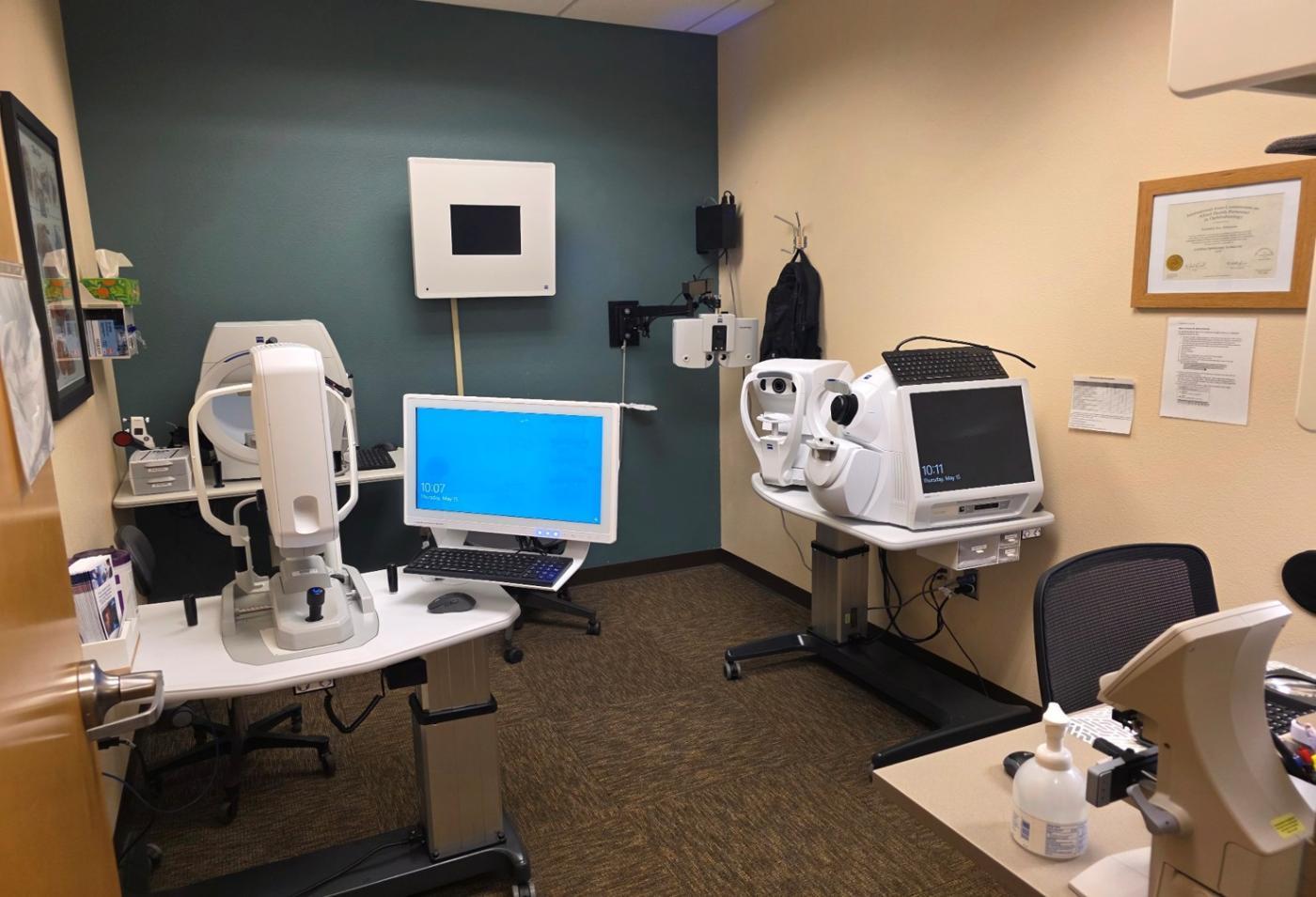 Medical room with several machines and a desk.