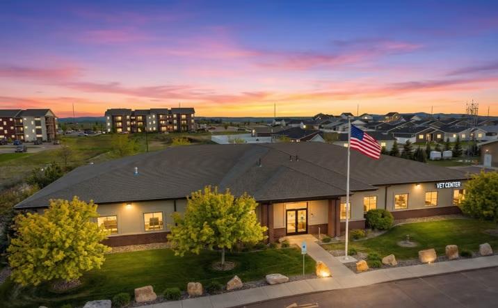 Aerial view of a building at dusk with American flag.