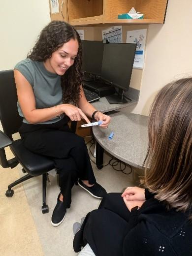 Pharmacy resident providing education in clinic.