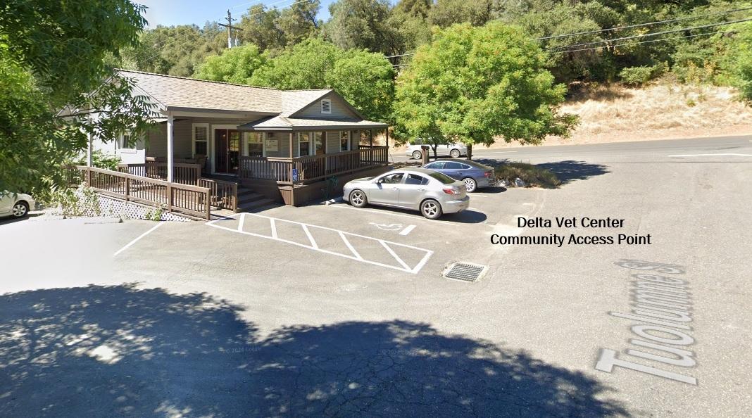Aerial view of a small building with cars parked outside.