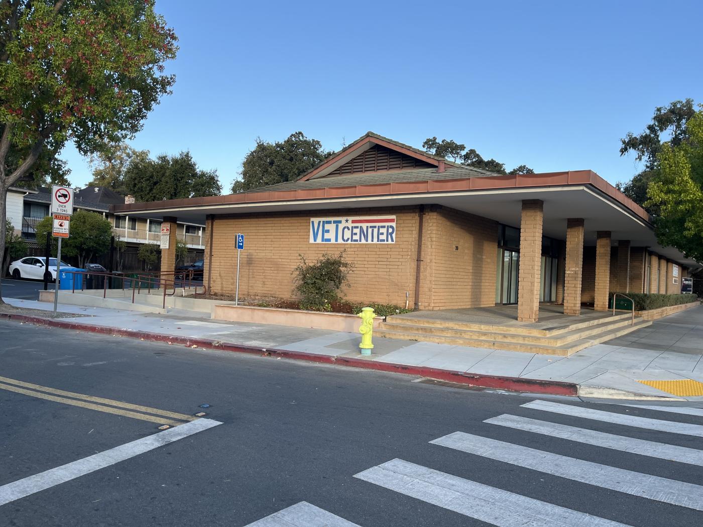 Street view of Vet Center with sign, sidewalk, and crosswalk.